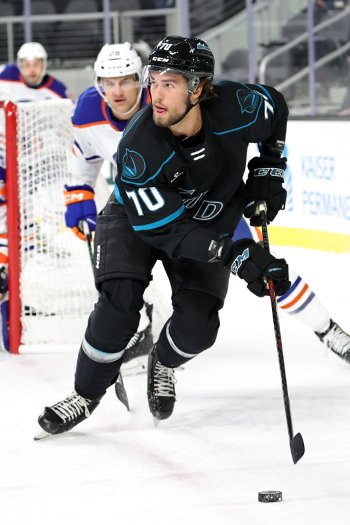 Brandon Coe looks to clear the puck