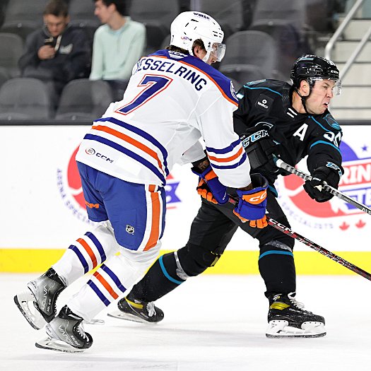 Derrick Pouliot (55) takes a shot on goal as Michael Kesselring (7) defends