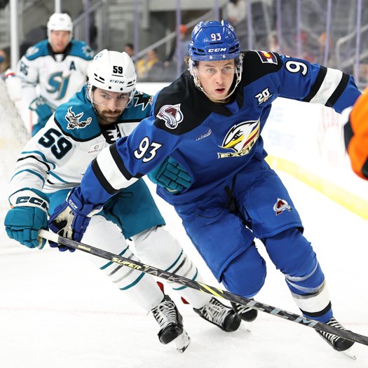 Jean-Luc Foudy (93) and Nick Cicek (59) chase the puck in the corner
