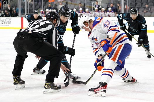 Luke Johnson (76) and Drake Rymsha (43) faceoff during first period action
