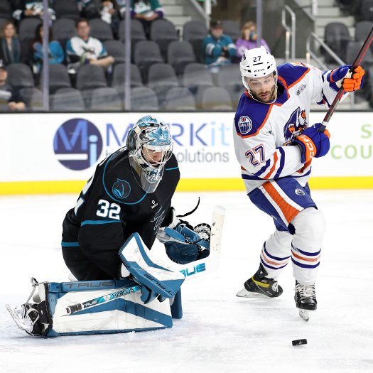 Matt Boudens (27) looks for the rebound in front of Barracuda's goalie Evan Buitenhuis