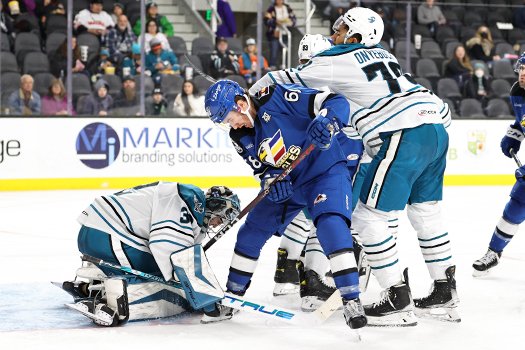 Montana Onyebuchi (79) shoves Callahan Burke (68) away from goalie Eetu Makiniemi