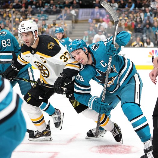Patrice Bergeron (37) and Logan Couture (39) follow the puck after a face-off