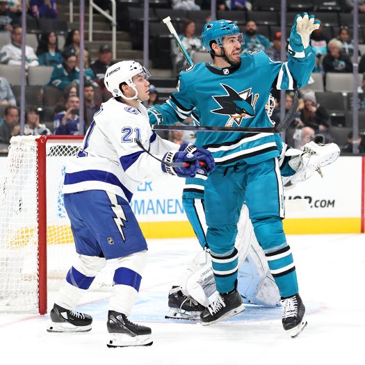 Sharks defenseman Jaycob Megna (24) reaches for a loose puck into front of Brayden Point (21)