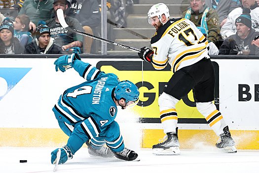 Sharks' defenseman Scott Harrington (4) tries to block a pass by Nick Foligno (17)