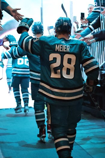 Timo Meier high-fives fans as he enters the ice